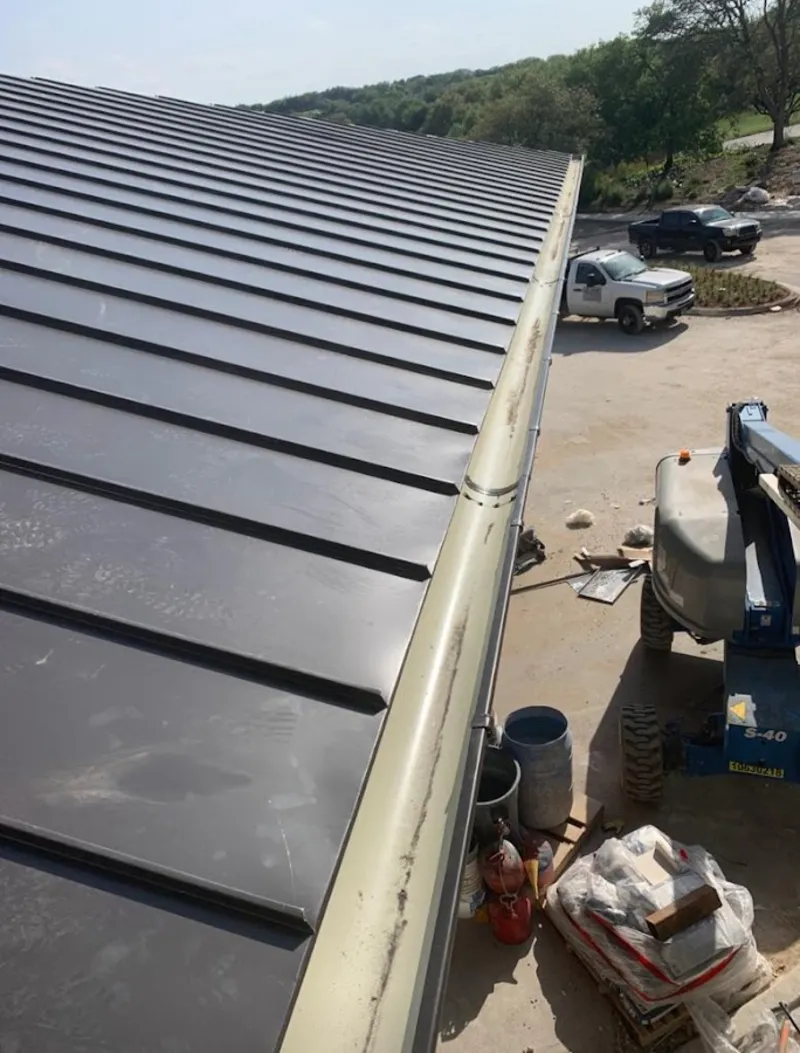 Standing seam panel and gutter detail on a metal roofing jobsite in Apache Junction